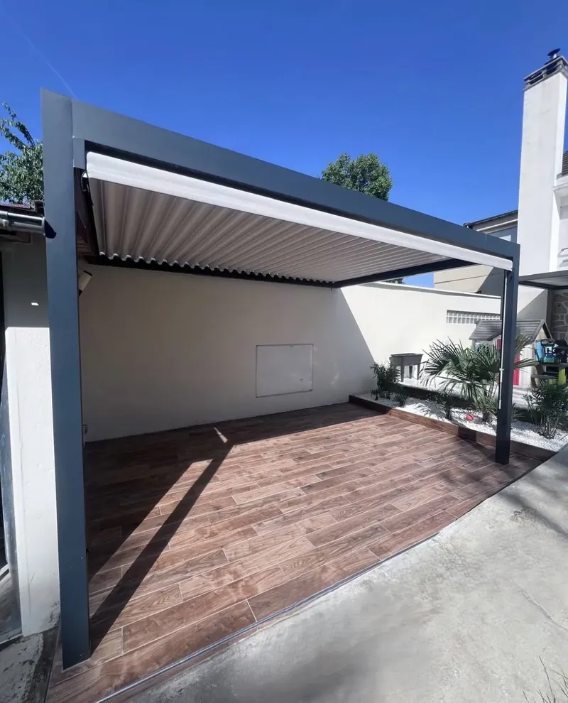 Lames de la pergola refermées au-dessus du carrelage extérieur